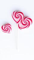 Heart-Shaped Lollipops on a White Background photo
