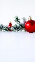Christmas Ornaments and Pine Branch on White Background photo