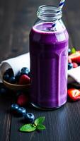 Blueberry Smoothie in a Glass Jar with Fresh Berries photo