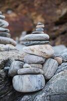 serene beach scene with smooth rocks stacked in a balanced formation. The tranquil atmosphere evokes a sense of zen, harmony, and peace, symbolizing balance and mindfulness in nature photo