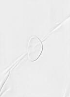 High-resolution white paper texture featuring subtle creases and folds, ideal for backgrounds, design, and overlays. photo