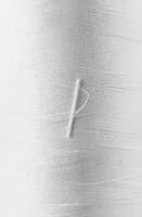 Close-up of White Thread Texture with Soft Fibers and Fine Lines photo