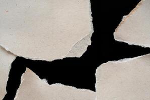 Abstract Torn Paper Texture with Jagged Edges on Black Background photo