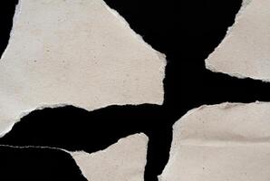 Abstract Torn Paper Texture with Jagged Edges on Black Background photo