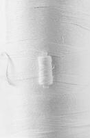 Close-up of White Thread Texture with Soft Fibers and Fine Lines photo