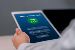 Hand holding a tablet displaying an online payment login screen. digital banking and secure financial transactions. finance online banking guides, and digital payment security articles. photo