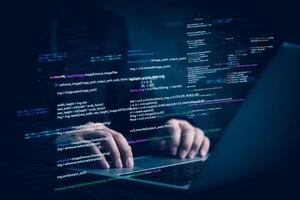 Hands typing on laptop with programming code on screen, representing software development. Perfect for coding, IT solutions, digital technology, web applications. photo