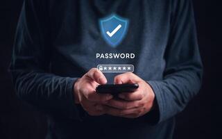 Man holding smartphone with password icon on dark background photo