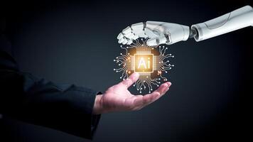 Human hand and robotic hand collaborating with glowing AI chip, symbolizing technological partnership. Ideal for AI integration, futuristic business strategies, innovation. photo