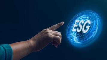 A hand reaching out to a futuristic, glowing ESG symbol, symbolizing the integration of Environmental, Social, and Governance principles in modern business practices. photo