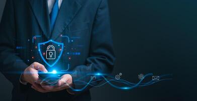 Businessman with a digital shield and lock icon, cybersecurity, and data protection.Privacy and trust in digital transactions. Perfect for IT services, and business presentations. High-tech security photo