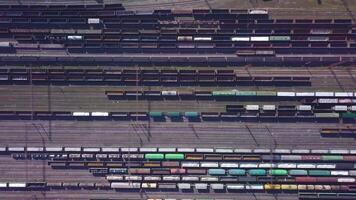 Aerial view of Railway sorting station and A lot of wagons at a railway. Drone flies over railway tracks. 4k quality video