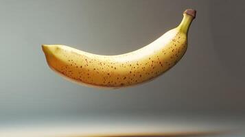 A Single Ripe Banana with Brown Spots in Mid-Air photo