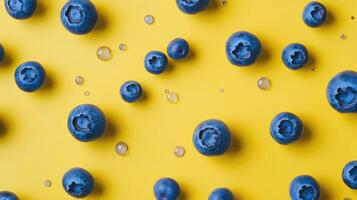 Blueberries and Water Droplets on Yellow Background photo