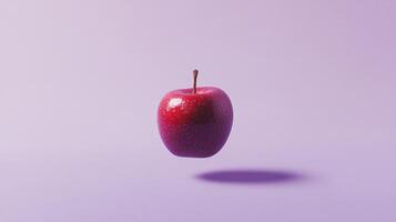 A Single Red Apple Floating Against a Light Purple Background photo
