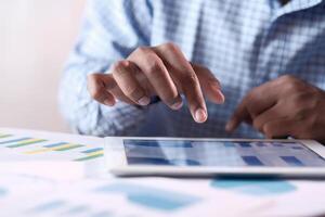 A skilled professional is using a tablet for detailed data analysis and insights photo