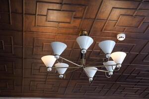 This is an Elegant Chandelier showcasing a Modern Design complemented by a Textured Ceiling photo