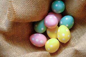 A Vibrantly Colorful Assortment of Easter Eggs Nestled Within a Rustic Burlap Basket photo