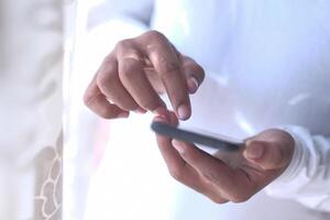 Closeup of hands using a smartphone for communication, highlighting modern interaction photo