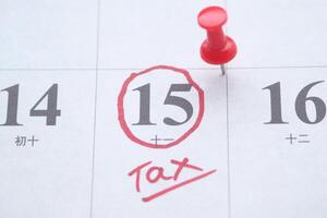 Tax Due Date Reminder on Calendar with a Red Pin to Indicate Urgency and Importance photo