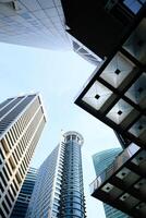 Modern Skyscrapers and Urban Architecture Viewed from Below in a Bustling City Setting photo