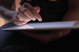 CloseUp of a Person Engaging with a Tablet Device Featuring a Touchscreen Interface photo
