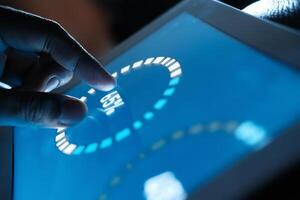 User Engaging with a Touchscreen Tablet Interface for Enhanced Interaction and Functionality photo