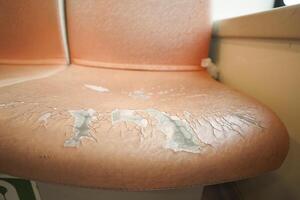 damage Leather with a cracked texture on a sofa . photo