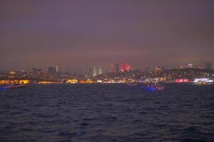 The Stunning Istanbul Night Skyline Features a Beautiful Display of Glowing Lights Over Water photo
