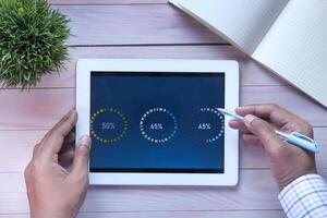 We are analyzing data on a tablet with progress indicators and a modern workspace design photo