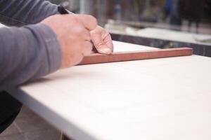 A skilled craftsman meticulously working with colorful tiles on a sturdy workbench photo