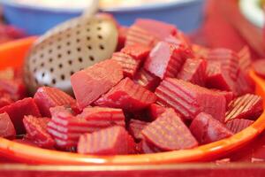 A bowl of freshly cut beetroot cubes, perfectly prepared for enjoyment or use in dishes photo