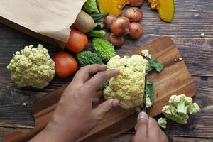 Preparation of Fresh Vegetables on a Wooden Cutting Board for Cooking Adventures photo
