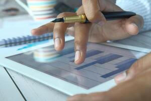Performing a comprehensive Business Analysis using a Digital Tablet, Pen, and Notepad photo