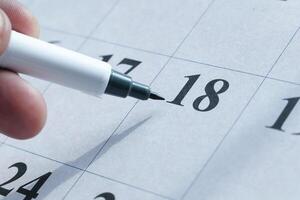 Remember to mark an important date on your calendar using a marker pen for visibility photo