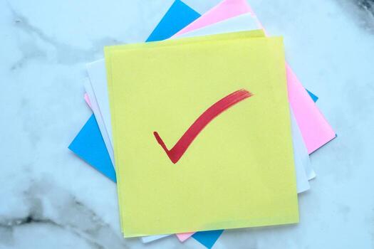 Bright and Colorful Sticky Notes Featuring a Red Checkmark Symbolizing Task Completion photo
