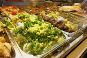 A Colorful Buffet Selection Featuring an Exquisite Array of Fresh Vegetables and Grilled Meats photo
