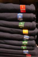 Stacked Clothing Sizes An Extensive Range of TShirts Offered in Various Sizes for Everyone photo
