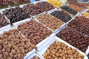 A Diverse Array of Delicious Varieties of Dates Artfully Displayed at a Vibrant Market Stall photo