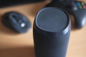 A detailed closeup view of a Portable Bluetooth Speaker accompanied by various Gaming Accessories photo