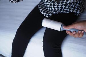 Utilizing a Lint Roller on Dark Pants Ensures a Neat and Clean Look for Your Outfit photo