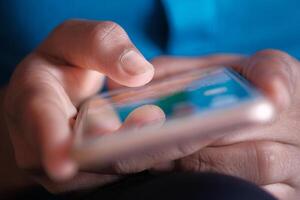 A closeup view of a hand actively using a smartphone to engage in social media interactions photo