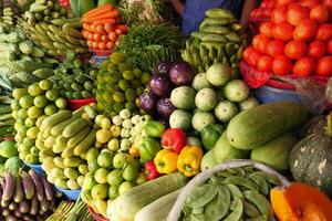 A Vibrant Market Scene Featuring an Abundance of Fresh Fruits and Vegetables of All Types photo