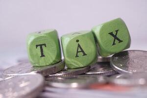 Exploring the Financial Concept of Taxation Through the Use of Coins and Dice Blocks in Detail photo