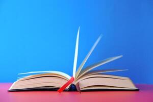 An Open Book with Pages Elegantly Turning Against a Bright and Colorful Background photo