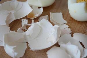 A closeup view of fragile eggshells beautifully arranged on a rustic wooden surface photo