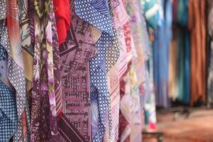 An EyeCatching Display of Colorful Textiles at a Local Market Stall for Shoppers Enthusiasts photo