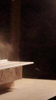 Close-up of a man cuts a wooden plank with an electric circular saw in a workshop. Cutting a piece of wood on a circular saw in backlight. Ideal topics related carpentry, efficient sawing techniques video
