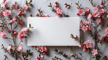 A white sign is placed in front of a pink flower arrangement photo
