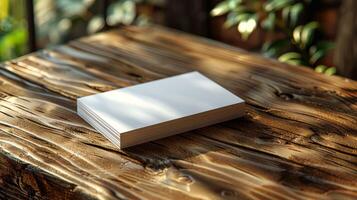 A white business card sits on a wooden table photo